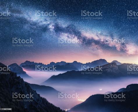 Milky Way Over Mountains In Fog At Night In Summer Landscape With Foggy