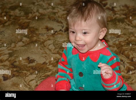 Close Up Head And Shoulders Portrait Of Little Baby Boy In Red Green