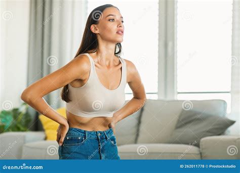 Slim Caucasian Woman Doing Belly Vacuum Abdominal Exercise Flexing