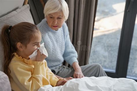 Worried Grandma Taking Care Of A Sick Kid In Bed Stock Image Image Of