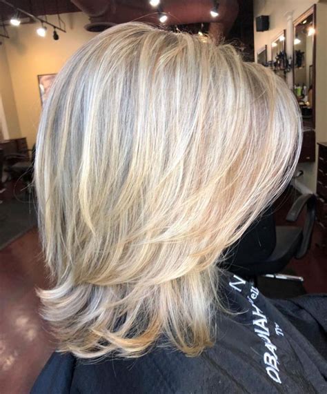 Above The Shoulder Feathered Blonde Haircut Medium Layered Haircuts