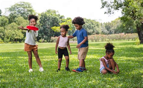 Premium Photo African American Kids Play Frisbee In The Park