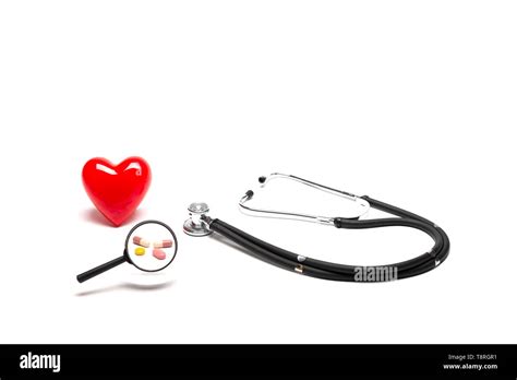 Front View Of Plastic Red Heart Model Stethoscopes And Drugs With