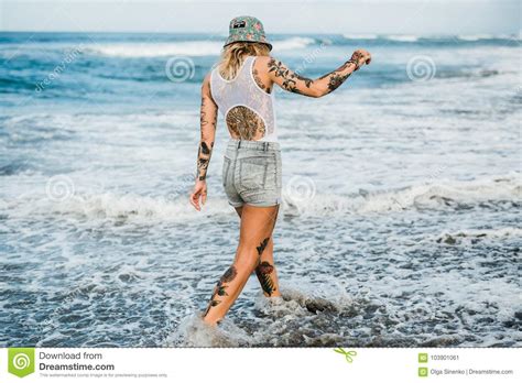 tattooed woman walking at beach stock image image of girl female 103901061