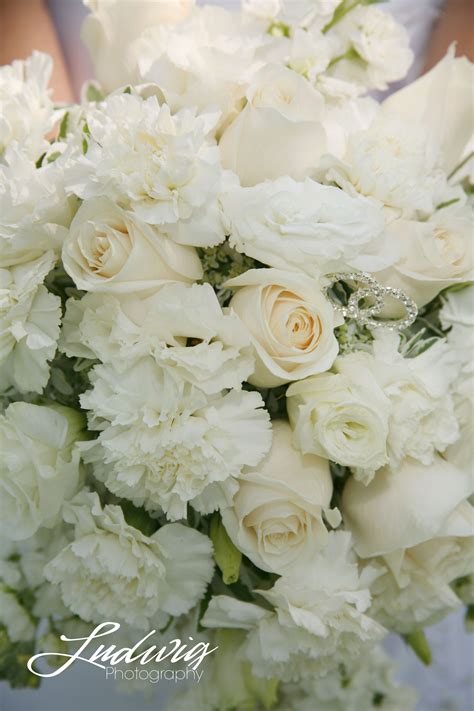 A Wedding Bouquet Of White Roses And Carnations Wedding Photography