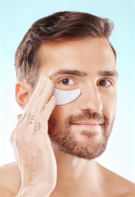 Face Skincare And Man With Eye Patch In Studio Isolated On A Blue