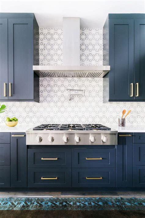 Gray laminate kitchen countertop in a creamy white kitchen. Kitchen with dark blue cabinents, gold fixtures, dove gray ...