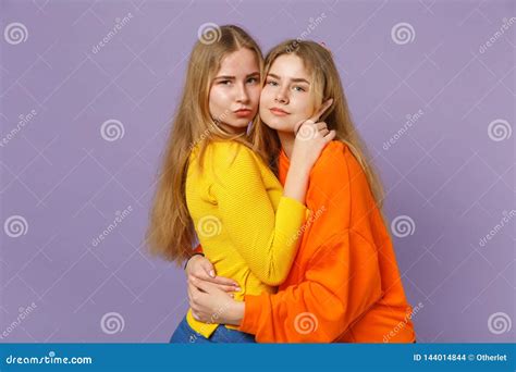Two Beautiful Young Blonde Twins Sisters Girls In Vivid Colorful