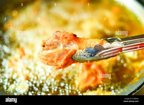 Fried Chicken Cooking From Skillet Stock Photo Alamy