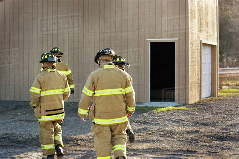 Firefighters Walking Towards Building Stock Photo Dissolve