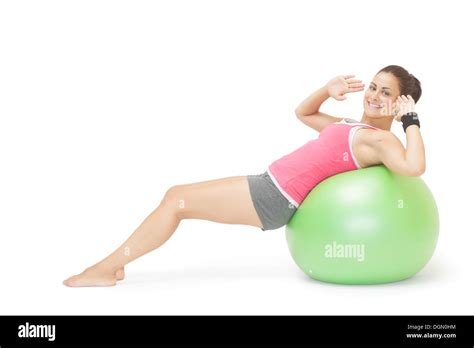 Smiling Sporty Brunette Doing Sit Ups On Exercise Ball Stock Photo Alamy