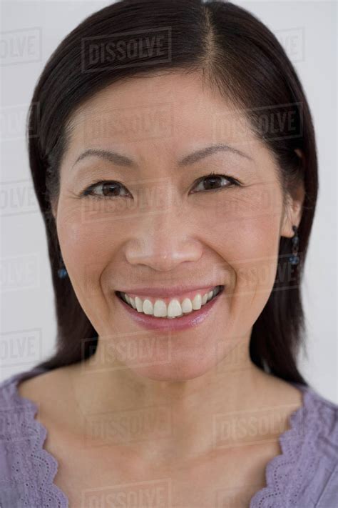 Close Up Of Middle Aged Asian Woman Smiling Stock Photo Dissolve