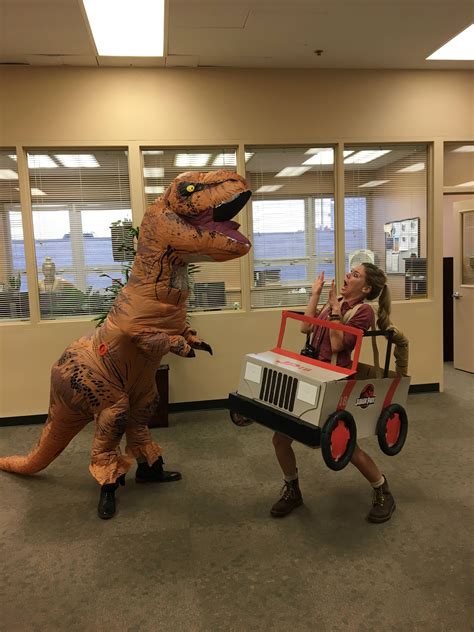 Two People Dressed As Dinosaurs In An Office