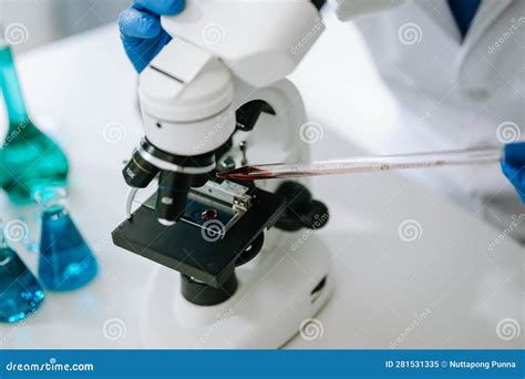 Male Scientist Researcher Conducting An Experiment In Laboratory Stock