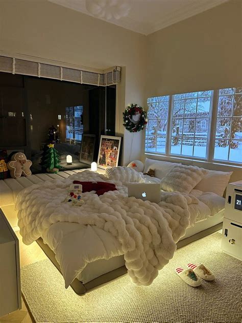 A Large Bed Sitting In The Middle Of A Living Room Next To Two Windows