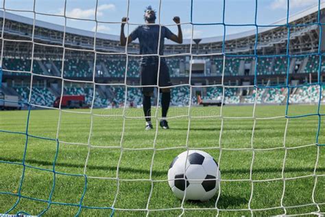 Soccer Player Kicks The Ball Into The Goal At The Stadium Stock Image