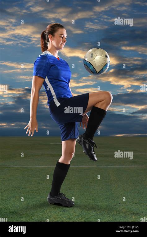 Female Soccer Player Bouncing Ball On Knee At Dusk Stock Photo Alamy