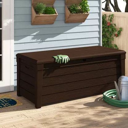 An Outdoor Storage Box With Plants Growing Out Of It