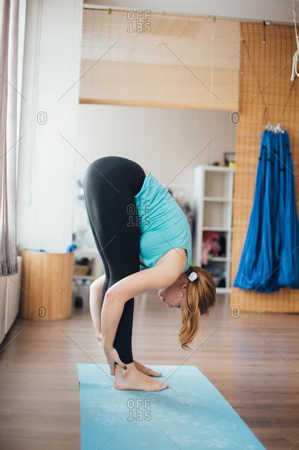 Woman Bending Over And Stretching In A Yoga Studio Stock Photo Offset