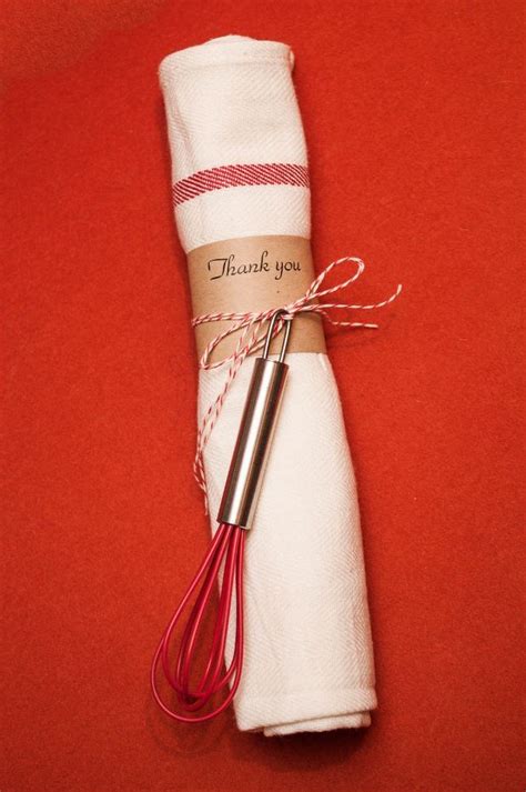 A Red Whisk On Top Of A White Napkin With A Thank You Message