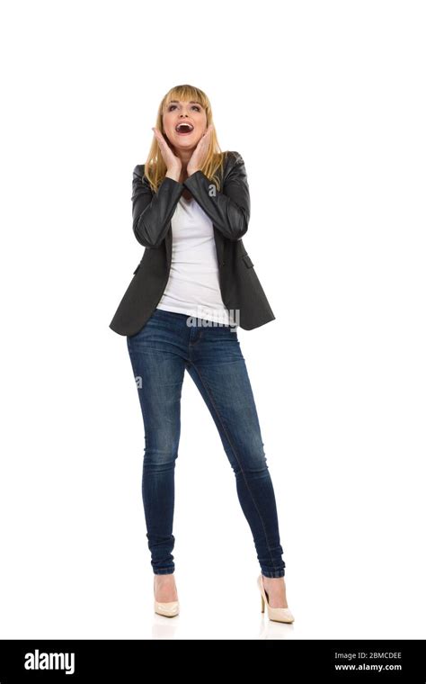 Surprised Young Woman In Unbuttoned Black Tail Jacket Blue Jeans And