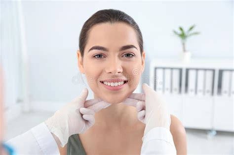 Dermatologist Examining Patient`s Face In Clinic Stock Image Image