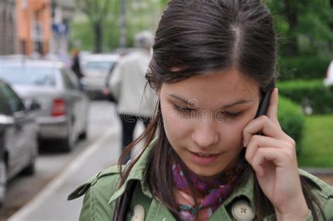 Young Woman Walking On The Street And Talking On The Phone Stock Image