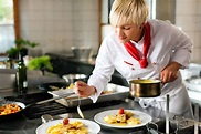 Female chef in a restaurant or hotel kitchen cooking - stock photo ...
