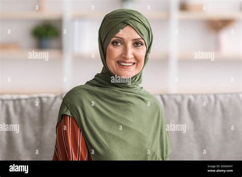 Portrait Of Happy Mature Middle Eastern Woman Wearing Hijab At Home