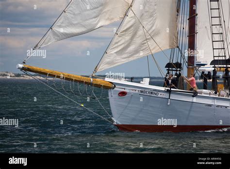 Two Crew Members Help Tack The Two Masted Schooner Timberwind During A