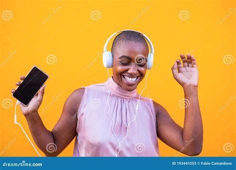 Happy African Or American Woman Dancing And Vibing Alone With Her Phone