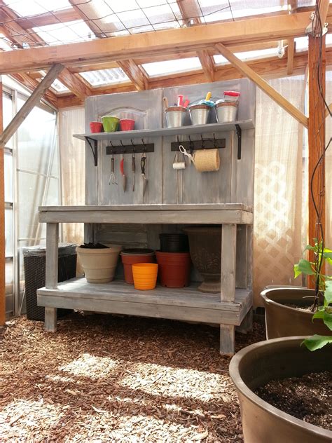 An Old Wooden Shelf With Pots And Pans On It In A Garden Shed Or Greenhouse