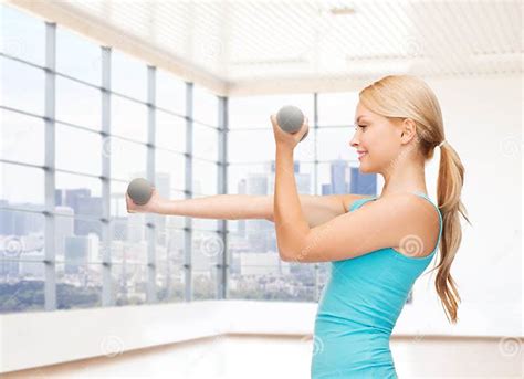 Smiling Woman With Dumbbells Flexing Biceps In Gym Stock Image Image