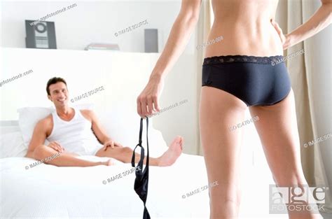 Woman Undressing For Man Stock Photo Picture And Royalty Free Image