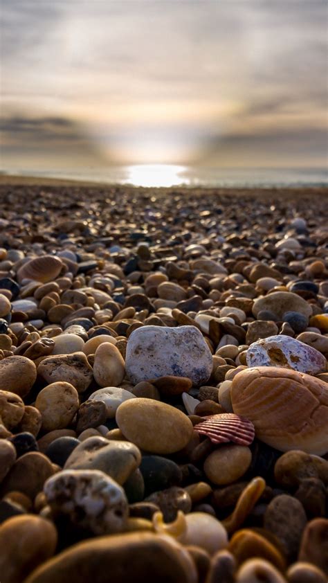 Download Wallpaper 938x1668 Beach Pebbles Sea Stones Sky Rays