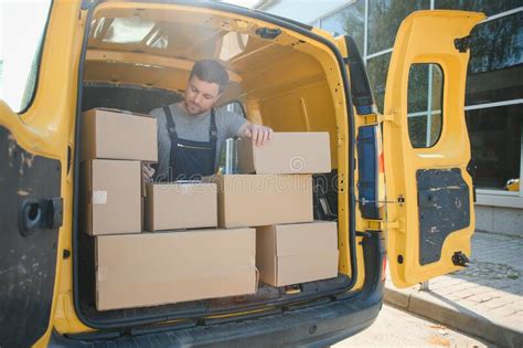 Delivery Men Unloading Moving Boxes From Car Stock Image Image Of