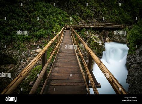 Footbridge Over Waterfall Stock Photo Alamy