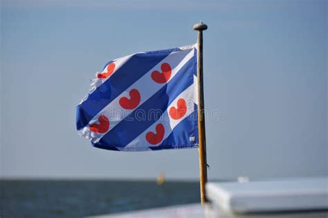 flag in front motor yacht frisian flag representing the province of friesland in the