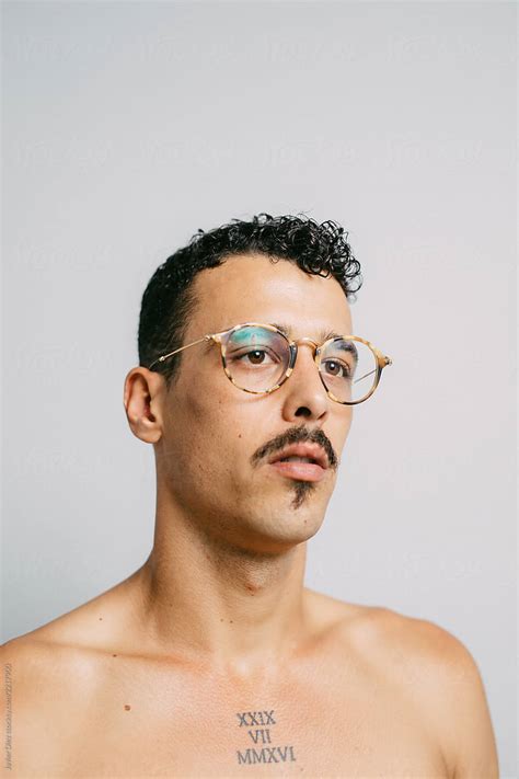 Tattooed Curly Man In Glasses By Stocksy Contributor Javier Díez