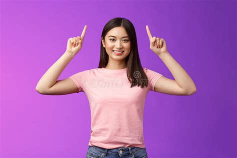 Cute Assertive Dark Haired Asian Woman Wear Pink T Shirt Raise Hands Up