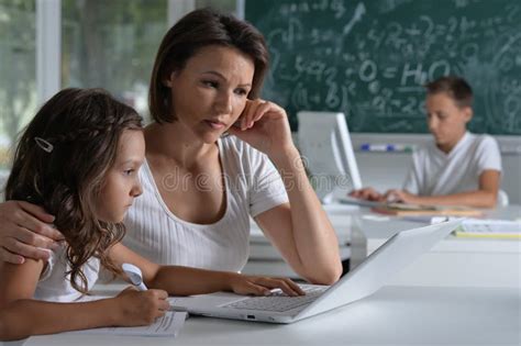 Children At School In The Classroom With Teacher Stock Photo Image Of