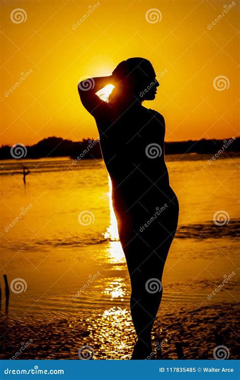 Hispanic Brunette Model Enjoying An Early Morning Sunrise Stock Image