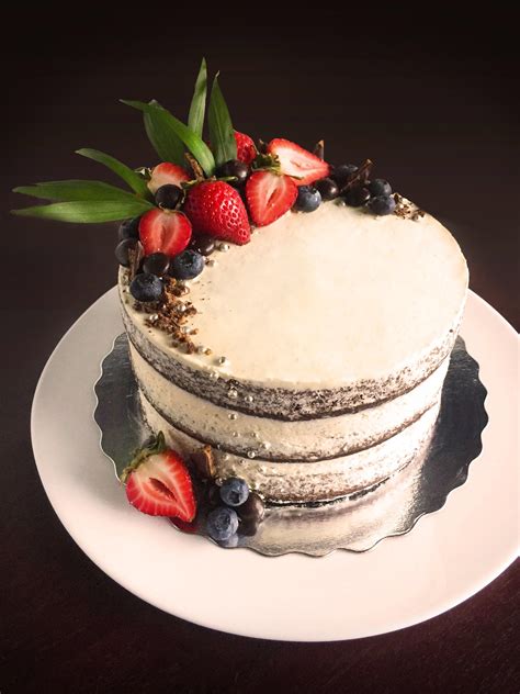 A Naked Chocolate Cake With Nutella Filling Topped With Fresh Fruit