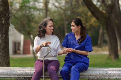 Healthcare Nurse Physical Therapy With Elderly Woman At Outdoor Nurse Holding Hand And Help