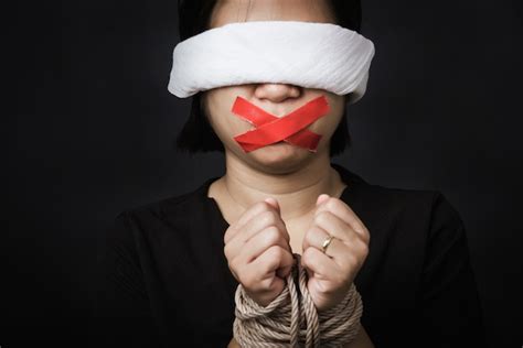 premium photo slave woman blindfold wrapping mouth with red adhesive tape tied with chains