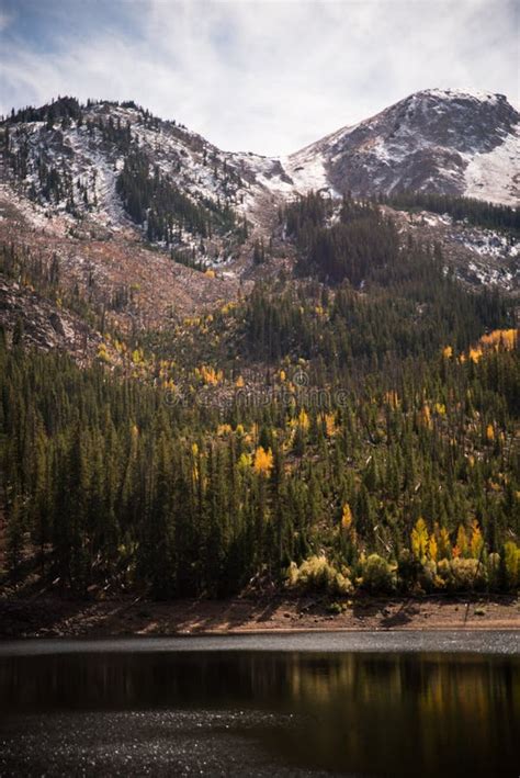Landscape View Of A Lake Snow Capped Mountains And Fall Foliage Near