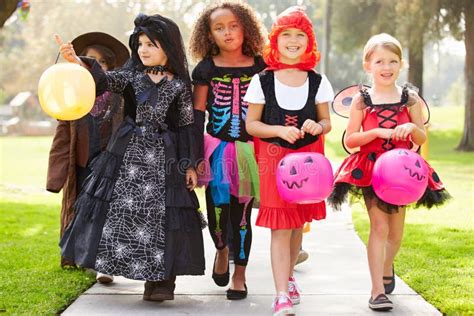 Children In Fancy Costume Dress Going Trick Or Treating Stock Image
