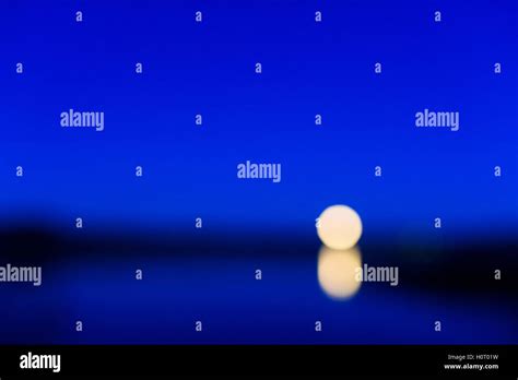 Moonrise Over Lake Stock Photo Alamy