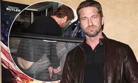 gerard butler reveals a little too much derriere as he bends down to remove his shoes for
