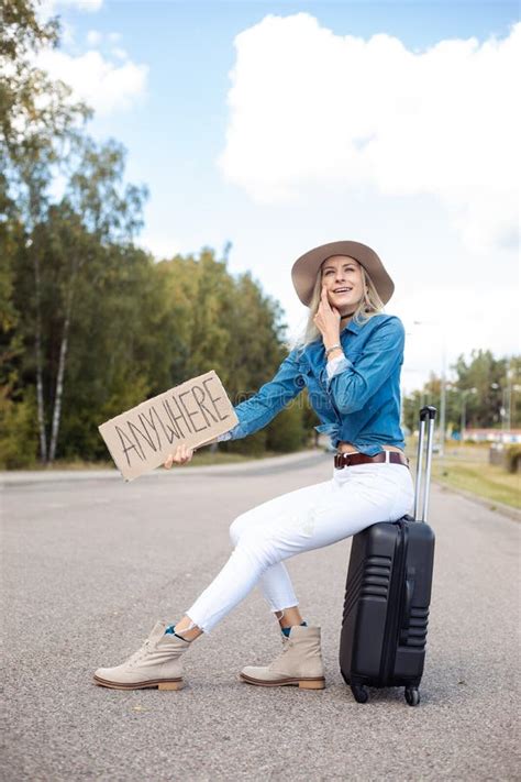 Vertical Smiling Laughing Blond Woman In Cowgirl Hat Hitchhike By Roadway With Cardboard Plate
